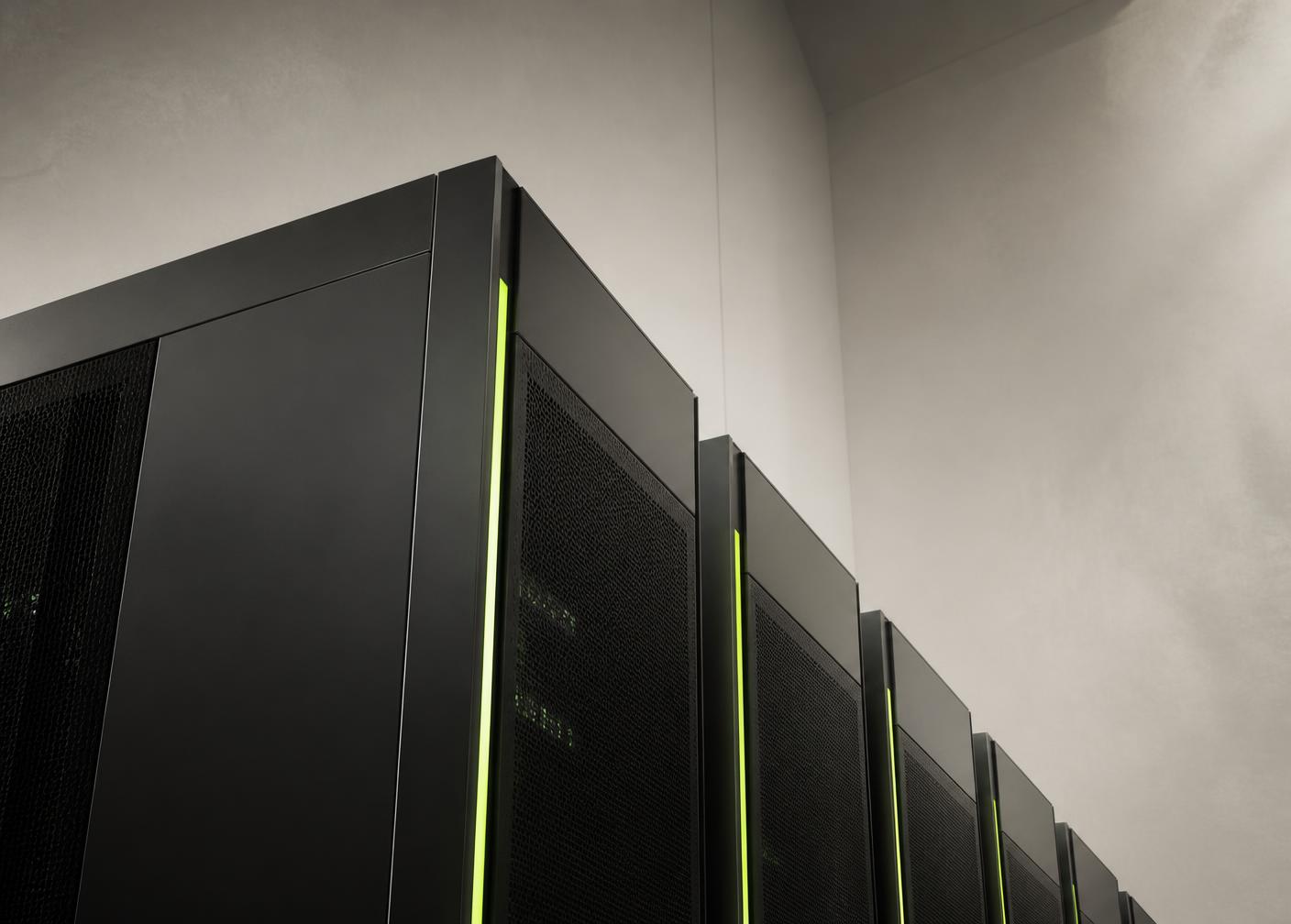 A row of dark server cabinets lit by narrow vertical green light strips